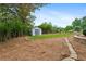 Landscaped backyard featuring an artificial turf area, storage shed, and mature trees for added privacy at 834 Timberland Se St, Smyrna, GA 30080
