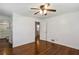Bedroom with wood floors, ceiling fan and white walls leading to bathroom and closet at 834 Timberland Se St, Smyrna, GA 30080