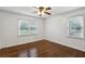 Bedroom with wood floors, a ceiling fan, two windows, and white walls at 834 Timberland Se St, Smyrna, GA 30080