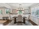 Elegant dining room with stylish lighting, wainscoting, and seamlessly connected to the kitchen at 834 Timberland Se St, Smyrna, GA 30080