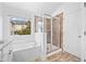 Bright bathroom featuring a soaking tub and glass enclosed shower at 3729 Inglewood Ne Way, Atlanta, GA 30319