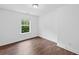 Cozy bedroom with hardwood floors and a window looking out to greenery at 3729 Inglewood Ne Way, Atlanta, GA 30319