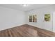 Bright bedroom features hardwood floors, neutral walls, window, and exterior access at 3729 Inglewood Ne Way, Atlanta, GA 30319