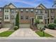 Charming brick townhome with well-manicured landscaping, a private garage, and inviting front entrance at 3729 Inglewood Ne Way, Atlanta, GA 30319