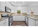 Well-lit kitchen featuring white cabinets, granite countertops, and stainless steel appliances at 3729 Inglewood Ne Way, Atlanta, GA 30319