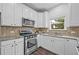 Bright kitchen boasting white cabinets, granite countertops, and modern appliances for cooking enjoyment at 3729 Inglewood Ne Way, Atlanta, GA 30319