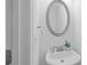 Bright powder room with a stylish oval mirror and white sink at 3729 Inglewood Ne Way, Atlanta, GA 30319