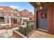 Welcoming front entrance with pergola and flowering shrubs, enhancing the townhome's curb appeal at 387 Ralph Mcgill Ne Blvd # K, Atlanta, GA 30312