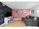 A comfortable living room featuring modern wallpaper, hardwood floors, and large sectional couch at 387 Ralph Mcgill Ne Blvd # K, Atlanta, GA 30312