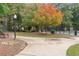 A well-maintained path winds through the community's lush landscaping, with a bench and colorful autumn trees at 387 Ralph Mcgill Ne Blvd # K, Atlanta, GA 30312