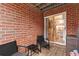 Outdoor patio space with brick walls, outdoor seating, and sliding door to indoor area at 387 Ralph Mcgill Ne Blvd # K, Atlanta, GA 30312