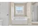 En-suite bathroom includes a soaking tub with a window view and walk in shower at 422 Inwood Trail Trl, Lawrenceville, GA 30043