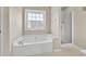 En-suite bathroom with soaking tub with window view and walk in shower at 422 Inwood Trail Trl, Lawrenceville, GA 30043
