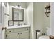 Clean and modern half-bathroom featuring a vanity, toilet, and decor at 422 Inwood Trail Trl, Lawrenceville, GA 30043
