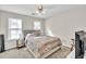 Neutral bedroom featuring plush carpet, a Queen-sized bed, side table and window at 422 Inwood Trail Trl, Lawrenceville, GA 30043