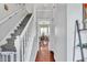 Hallway with hardwood floors leading to a staircase and a view of the dining room at 422 Inwood Trail Trl, Lawrenceville, GA 30043