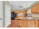 Charming kitchen featuring custom wood cabinetry, granite countertops, and modern black appliances at 422 Inwood Trail Trl, Lawrenceville, GA 30043