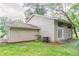 Exterior rear view of the home featuring a blend of siding and multiple windows at 4715 Wildginger Run, Lithonia, GA 30038