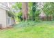 The home's exterior with yard, patio, and lush vegetation at 4715 Wildginger Run, Lithonia, GA 30038