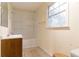 Bathroom featuring tile floors, shower-tub combo, sink, and window at 4715 Wildginger Run, Lithonia, GA 30038