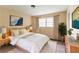 Bedroom features a large window, artwork, plush rug and wood dresser at 4715 Wildginger Run, Lithonia, GA 30038