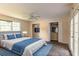 Bedroom with large windows, ceiling fan, walk-in closet and neutral decor at 4715 Wildginger Run, Lithonia, GA 30038
