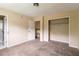 A bedroom featuring multiple doorways and an open closet at 4715 Wildginger Run, Lithonia, GA 30038