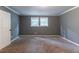 This bedroom features a window and plush carpet at 4715 Wildginger Run, Lithonia, GA 30038