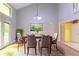 Dining room with wood table, six chairs, french doors, and modern light fixture at 4715 Wildginger Run, Lithonia, GA 30038