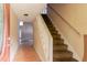 Hallway with carpet stairs leading to the second floor and hardwood floors at 4715 Wildginger Run, Lithonia, GA 30038