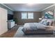 Bedroom with soft blue bedding, carpet floors, and contemporary decor at 4715 Wildginger Run, Lithonia, GA 30038