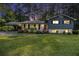 Charming two-story home with a well-manicured lawn and a covered carport at 6085 Dunbritan Ln, Atlanta, GA 30349