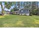 Well-maintained two-story home with a lush green lawn and mature trees at 6085 Dunbritan Ln, Atlanta, GA 30349