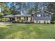 Charming two-story home with a well-manicured lawn and a covered carport at 6085 Dunbritan Ln, Atlanta, GA 30349