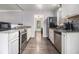 Modern kitchen with stainless steel appliances, granite countertops and laminate floors at 6085 Dunbritan Ln, Atlanta, GA 30349