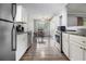 Bright kitchen featuring stainless steel appliances, laminate flooring, and ample cabinet space at 6085 Dunbritan Ln, Atlanta, GA 30349