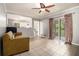 Inviting living room with tile floors, a ceiling fan and sliding door access to the outdoors at 6085 Dunbritan Ln, Atlanta, GA 30349