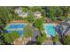 Community aerial view featuring a swimming pool, tennis courts, and green spaces at 6260 Sturbridge Ln, Cumming, GA 30040