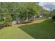 Serene backyard with lush greenery, a level lawn, and a designated seating area for relaxation at 6260 Sturbridge Ln, Cumming, GA 30040