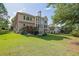 Spacious backyard featuring a well-manicured lawn, mature trees, and a private outdoor space at 6260 Sturbridge Ln, Cumming, GA 30040