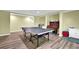 Spacious basement featuring a ping pong table and ample space for recreation and entertainment at 6260 Sturbridge Ln, Cumming, GA 30040