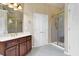 Updated bathroom featuring a shower, glass door, white cabinets, and modern fixtures with a tiled floor at 6260 Sturbridge Ln, Cumming, GA 30040