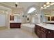 Bright bathroom featuring dual vanities, a large bathtub, tiled floors, and mirrors reflecting ample natural light at 6260 Sturbridge Ln, Cumming, GA 30040