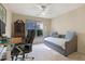 Bright bedroom featuring a daybed, ceiling fan, and a cozy workspace with neutral walls at 6260 Sturbridge Ln, Cumming, GA 30040