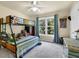Spacious bedroom features a bunk bed, dresser, and a large window with backyard views at 6260 Sturbridge Ln, Cumming, GA 30040