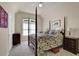 Serene bedroom boasts a four-poster bed, a ceiling fan, and calming decor for a peaceful retreat at 6260 Sturbridge Ln, Cumming, GA 30040