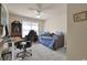 Cozy bedroom offers a daybed, desk area, ceiling fan and ample natural light for a versatile living space at 6260 Sturbridge Ln, Cumming, GA 30040