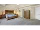 Primary bedroom with neutral walls, classic furniture, soft lighting, and a light gray carpeted floor at 6260 Sturbridge Ln, Cumming, GA 30040