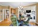 Inviting dining area with views into the living room and a stylish lighting fixture at 6260 Sturbridge Ln, Cumming, GA 30040
