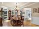 Bright dining area with hardwood floors, a large table, and classic furnishings at 6260 Sturbridge Ln, Cumming, GA 30040